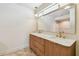 Modern bathroom featuring a double vanity with gold fixtures and a large mirror at 11683 Grove St, Seminole, FL 33772
