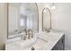 Close-up of bathroom vanity with marble countertop, gold faucets, and decorative mirrors at 11683 Grove St, Seminole, FL 33772