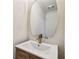 Bathroom vanity features decorative gold faucet, decorative mirror and white countertop at 11683 Grove St, Seminole, FL 33772