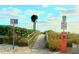 Beach access with parking and signs provides easy entry to the sandy shore at 11683 Grove St, Seminole, FL 33772
