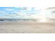 Expansive beach view with gentle waves and a clear sky, ideal for relaxation at 11683 Grove St, Seminole, FL 33772