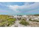 Scenic beach view with dunes and ocean, showcasing a relaxing coastal lifestyle at 11683 Grove St, Seminole, FL 33772