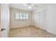 Bedroom with tile flooring, plantation shuttered window and closet with shuttered doors at 11683 Grove St, Seminole, FL 33772
