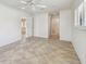Bedroom featuring neutral tile flooring, white walls, and a large window with shutter-style blinds at 11683 Grove St, Seminole, FL 33772