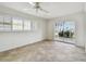 Bedroom featuring neutral tile flooring, a sliding glass door, and large windows with shutter-style blinds at 11683 Grove St, Seminole, FL 33772