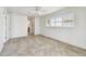 Bedroom with neutral tile flooring, white walls, and a large window with shutter-style blinds at 11683 Grove St, Seminole, FL 33772