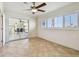 Bedroom featuring a fan, tile floors, and outdoor access at 11683 Grove St, Seminole, FL 33772