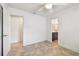 Open bedroom featuring tile flooring, a ceiling fan, and an ensuite bathroom at 11683 Grove St, Seminole, FL 33772