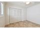 This bedroom features neutral walls, tile floors, a ceiling fan, and a spacious closet at 11683 Grove St, Seminole, FL 33772