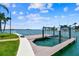 Waterfront property featuring a private dock with boat lift, canal access, and stunning water views at 11683 Grove St, Seminole, FL 33772
