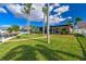 Beautiful waterfront home featuring mature landscaping, palm trees and a private dock at 11683 Grove St, Seminole, FL 33772