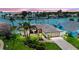 Inviting waterfront home featuring lush landscaping, a modern garage door, and serene water views at 11683 Grove St, Seminole, FL 33772