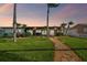Charming single-story home with manicured lawn, mature palms, and inviting walkway at 11683 Grove St, Seminole, FL 33772