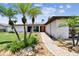 Beautiful home with an orange front door, lush landscaping, and a brick pathway at 11683 Grove St, Seminole, FL 33772