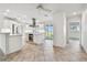 Modern kitchen featuring an island, stainless steel range hood, and tile floors at 11683 Grove St, Seminole, FL 33772