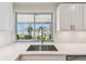 Stainless steel kitchen sink offers lovely water views from a large window at 11683 Grove St, Seminole, FL 33772