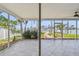 Enclosed lanai with tile flooring, views of the backyard, and a sliding glass door to the backyard at 11683 Grove St, Seminole, FL 33772
