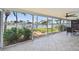 Enclosed lanai offers water views, tiled floor, ceiling fan and lush landscaping at 11683 Grove St, Seminole, FL 33772
