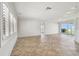 Bright living room with neutral tile flooring, recessed lighting, and a sliding glass door to a waterfront view at 11683 Grove St, Seminole, FL 33772