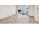 Bright living room with neutral tile flooring and a sliding glass door to a waterfront view at 11683 Grove St, Seminole, FL 33772