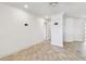Open living area with tiled floor, white walls, and doorways leading to other rooms at 11683 Grove St, Seminole, FL 33772