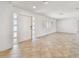 Open-concept living room with modern tiled floors and new front door at 11683 Grove St, Seminole, FL 33772