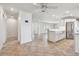Bright, open-concept living space with tile floors seamlessly connecting living, dining, and kitchen areas at 11683 Grove St, Seminole, FL 33772