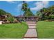 Landscaped walkway leading to a charming home at 1560 53Rd N St, St Petersburg, FL 33710