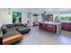 Open kitchen and living area with concrete island and modern appliances at 1560 53Rd N St, St Petersburg, FL 33710