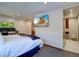 Bedroom with king-size bed, en-suite bathroom, and large TV at 1560 53Rd N St, St Petersburg, FL 33710