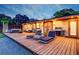 Evening view of a home with a large deck and lounge chairs at 1560 53Rd N St, St Petersburg, FL 33710