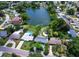 Aerial view of a lakefront property with lush landscaping and multiple houses at 1560 53Rd N St, St Petersburg, FL 33710