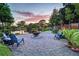 Peaceful fire pit area with lake view at sunset at 1560 53Rd N St, St Petersburg, FL 33710