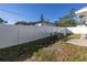 Small backyard with patio furniture and white vinyl fence at 1840 54Th N Ave, St Petersburg, FL 33714