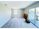 Bright bedroom with window, carpet, and sliding glass doors at 1960 Union St # 25, Clearwater, FL 33763