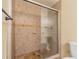 Clean shower with tile surround and sliding glass door at 2333 Feather Sound Dr # B101, Clearwater, FL 33762