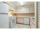 Efficient kitchen featuring white appliances and ample cabinetry at 2333 Feather Sound Dr # B101, Clearwater, FL 33762