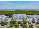 Aerial view of a waterfront condo building with lush landscaping at 2333 Feather Sound Dr # B101, Clearwater, FL 33762