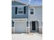 Two-story townhome showcasing a well-maintained facade with a garage and front door at 2472 Mellow Ln, Clearwater, FL 33765