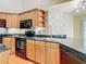 Well-equipped kitchen, boasting granite counters and black appliances at 364 Terrace Rd, Tarpon Springs, FL 34689