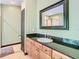 Bathroom with granite countertop, double sink vanity, and large mirror at 364 Terrace Rd, Tarpon Springs, FL 34689