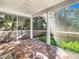 Spacious screened porch with tiled floor and backyard view at 364 Terrace Rd, Tarpon Springs, FL 34689