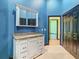 Bathroom with blue walls, vanity and mirror at 364 Terrace Rd, Tarpon Springs, FL 34689