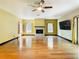 Bright living room with hardwood floors, fireplace, and sliding glass doors at 364 Terrace Rd, Tarpon Springs, FL 34689