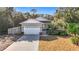 Gray house with a two-car garage and landscaped yard at 364 Terrace Rd, Tarpon Springs, FL 34689
