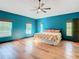 Spacious bedroom with teal walls, hardwood floors, and large windows at 364 Terrace Rd, Tarpon Springs, FL 34689
