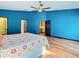 Spacious bedroom with blue walls, wood flooring, and a ceiling fan at 364 Terrace Rd, Tarpon Springs, FL 34689