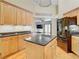 Modern kitchen with wood cabinets, granite island, and black appliances at 364 Terrace Rd, Tarpon Springs, FL 34689