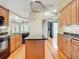 Modern kitchen with wood cabinets, granite island, and black appliances at 364 Terrace Rd, Tarpon Springs, FL 34689