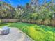 Landscaped backyard with grassy area and wooden fence at 364 Terrace Rd, Tarpon Springs, FL 34689